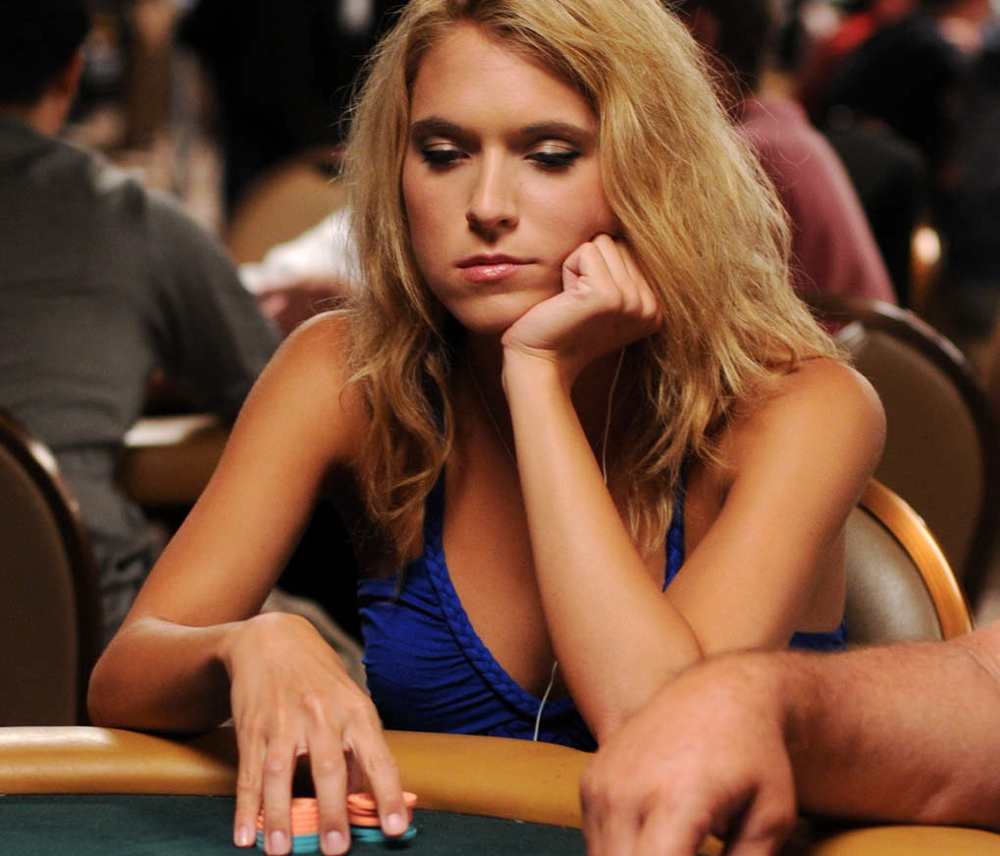 Pretty girl playing poker at the 2009 WSOP That dude's arm is ruining this photo for us. And the poker table.