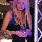 Tom 'durrrr' Dwan (right foreground) is sweated by his if-Tara-Reid-didn't-do-tons-of-drugs-this-is-what-she'd-maybe-look-like-now girlfriend at Event #3 of the 2009 WSOPE.